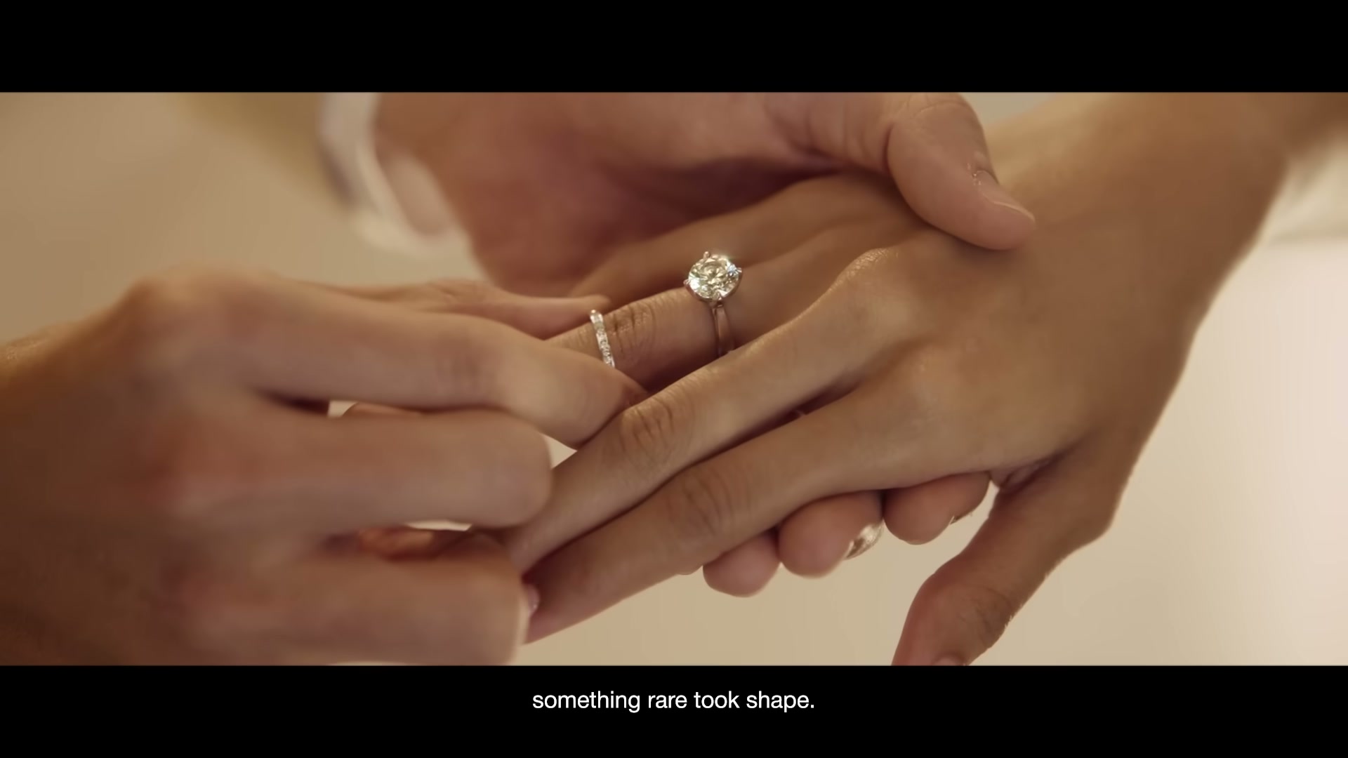 A diamond ring placed on a hand during a wedding celebration, from Frank & co.'s A Timeless Love campaign film.
